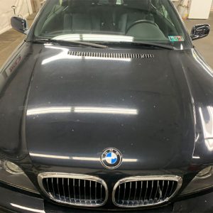 BMW emblem and car before detailing